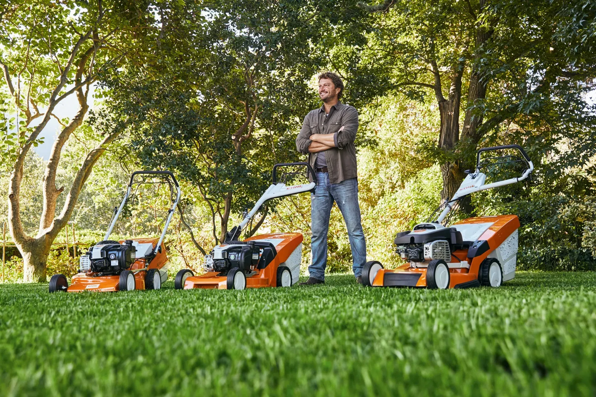 Different types of lawn mowers lined up side by side